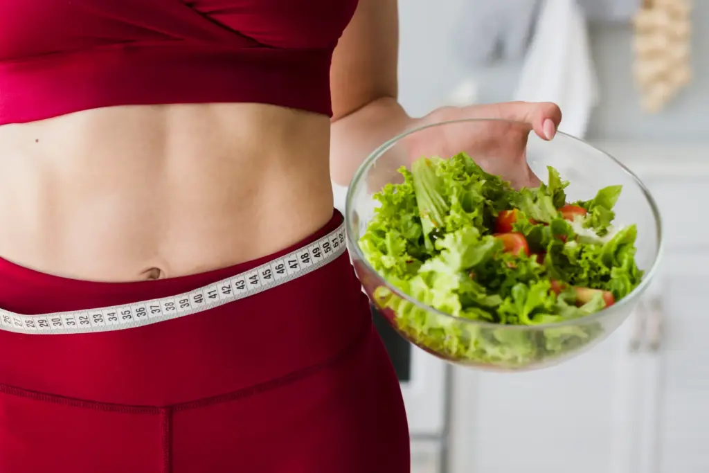 diet concept with sporty woman kitchen